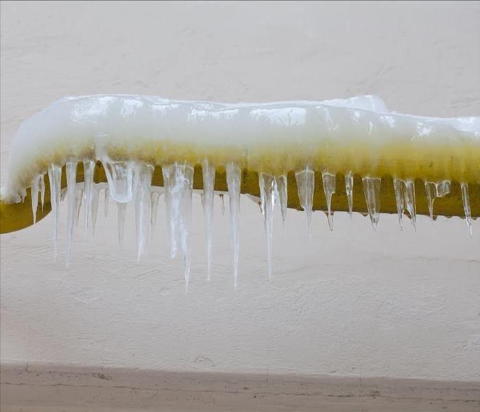 icicles on yellow water pipe