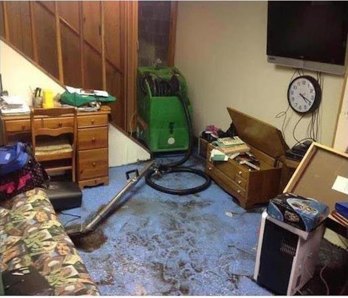 mudd on a blue floor with SERVPRO equipment